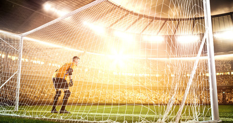 Intense soccer moment in front of the goal on the professional soccer stadium.