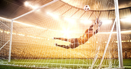 Intense soccer moment in front of the goal on the professional soccer stadium.
