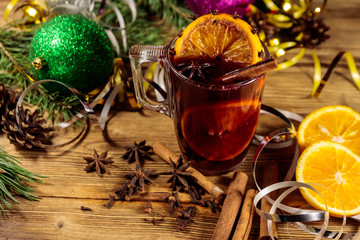 Christmas mulled wine with spices and Christmas decoration on wooden table