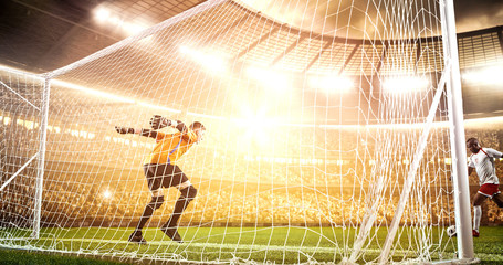 Intense soccer moment in front of the goal on the professional soccer stadium.