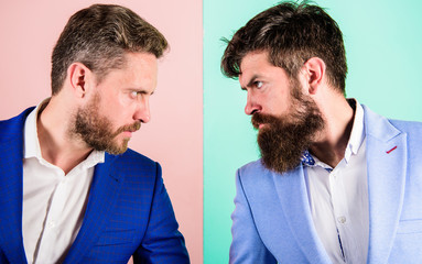 Business partners competitors or office colleagues in suits with tense bearded faces close up....