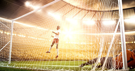 Intense soccer moment in front of the goal on the professional soccer stadium.