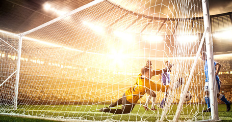 Intense soccer moment in front of the goal on the professional soccer stadium.