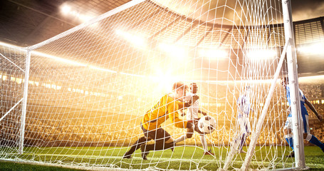 Intense soccer moment in front of the goal on the professional soccer stadium.
