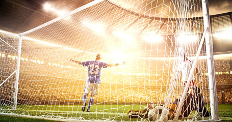 Intense soccer moment in front of the goal on the professional soccer stadium.