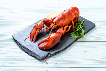 lobster with vegetable and lemon on black slate plate