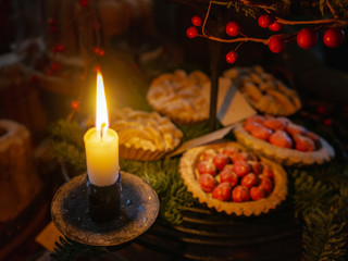 Advent candle with mini pie and berry Christmas decor