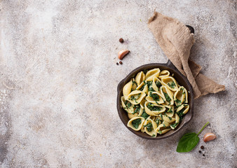 Conchiglioni pasta with spinach in creamy sauce 