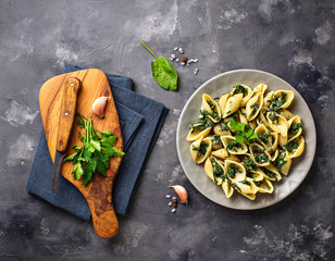 Conchiglioni pasta with spinach in creamy sauce 