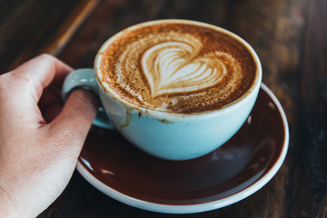 cup of coffee with cream on white background