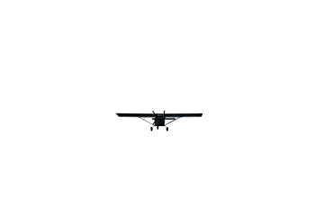 Light aircraft flying over white sky background