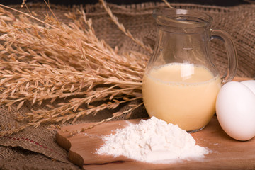 Spikelets of wheat, eggs, milk, flour. Ingredients for bakery products