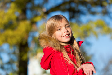 Naklejka premium Happy small girl on fresh air. Small girl happy smiling in autumn woods. Small fashion model. Childhood fashion for autumn season. Stylish and cute. Brown tints of an autumn