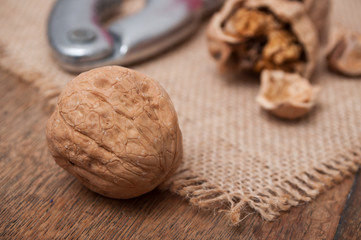 closeup of walnuts and Nutcracker on wooden background