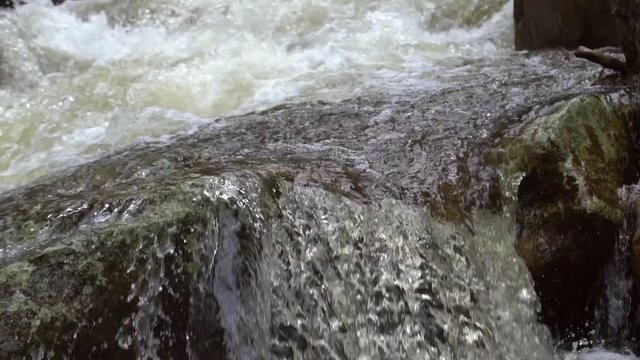 Water cascading over boulders in slow motion. On Rio Abanico on the Amazonian slopes of the Andes, Morona Santiago province, Ecuador