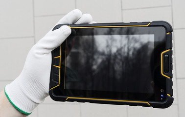 Hands holding industrial tablet. Engineer touch screen. Smart factory industrial. Worker using...