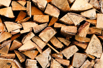 Firewood stacked near countryside village home.