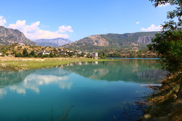 Fototapeta premium landscape with a lake and a village in the mountains on a sunny day