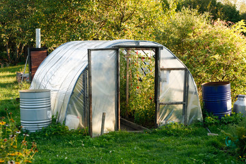 Fototapeta na wymiar Countryside home green house in garden.