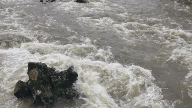 Aerial slow motion shot of a river in flood. The Rio Abanico on the Amazonian slopes of the Andes, Morona Santiago province, Ecuador, after heavy rain.