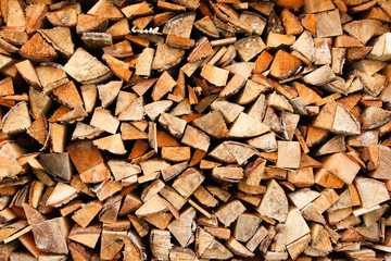 Beautiful wood stacked in a garage shelter near a countryside home.
