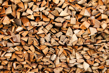 Beautiful wood stacked in a garage shelter near a countryside.
