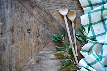 Mediterranean food background. Wooden table with checkered tablecloth and spoons
