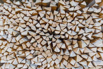 Dry chopped firewood logs ready for winter. Wood stack