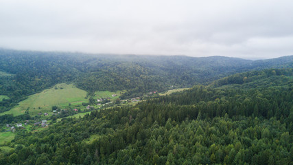 Beautiful cloudy green mountain landscape with trees in Carpathians