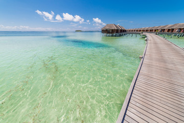 Beautiful beach with water bungalows at Maldives. Perfect beach panorama for summer travel destination banner background