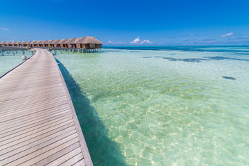 Beautiful beach with water bungalows at Maldives. Perfect beach panorama for summer travel destination banner background