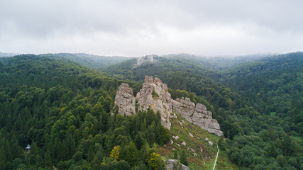 Fototapeta na wymiar Tustan rocks from above . Tustan castle aerial view fly over. Tustan was a Medieval cliff-side fortress-city and customs site of an Old Rus cliff-side defensive complex.