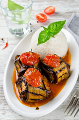 Meatballs wrapped in eggplant on a plate of rice