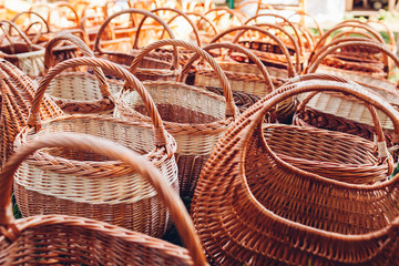 Straw baskets on sale in outdoor store. Wicker ukrainian bags on showcase of shop
