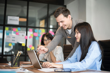 Business people are discussing about their work. Happy boss is talking to employee at workplace. Setup studio shooting.