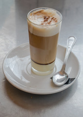Coffee with milk and  liqueur on crystal glass with some cinnamon