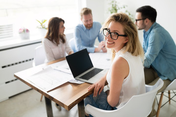 Happy business people working on project together