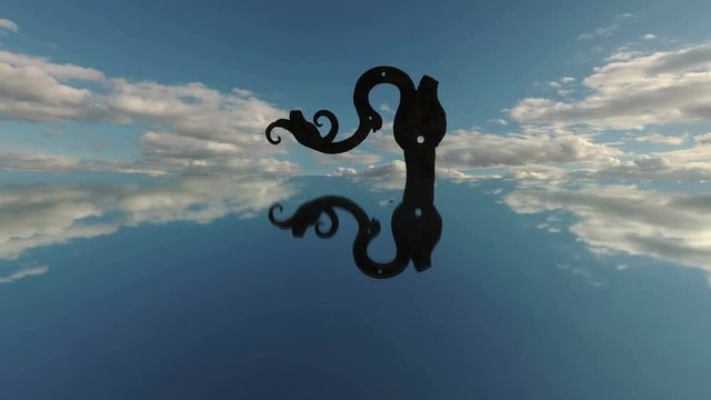 Old rusty metal scrap ornamental door hinge on mirror and clouds motion, time lapse