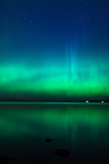 Beautiful northern lights aurora borealis over lake in finland