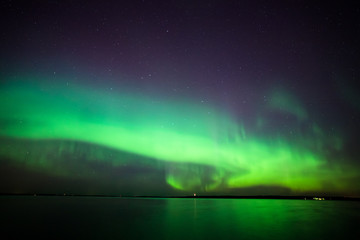 Beautiful northern lights aurora borealis over lake in finland
