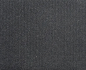 Fototapeta premium Texture of black corrugated cardboard. Dark surface, background