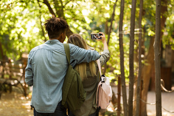 Back view young multiethnic couple spending time together