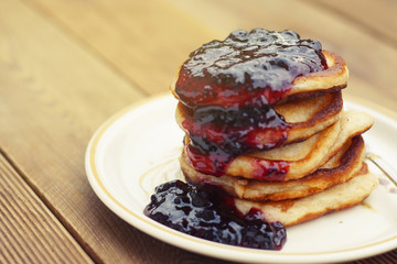 Homemade Breakfast, pancakeswith fruit jam, on wooden table. Pastry food. Dessert for kids.