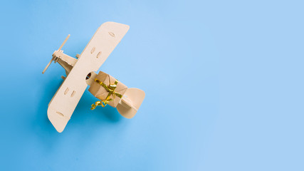 wooden children's plane on a blue background