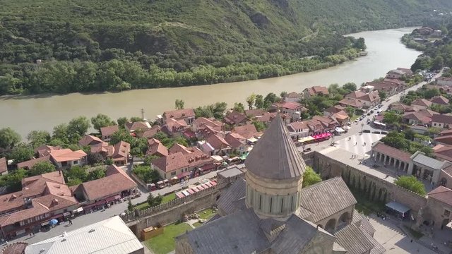 Aerial view to famous Svetitskhoveli Orthodox Cathedral and historical and touristic town Mtskheta, near Tbilisi, Georgia. On background mountains and river Aragvi