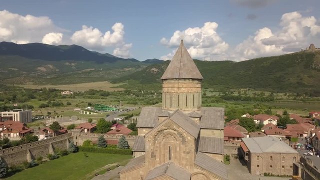 Aerial view to famous Svetitskhoveli Orthodox Cathedral and historical and touristic town Mtskheta, near Tbilisi, Georgia. On background mountains and river Aragvi