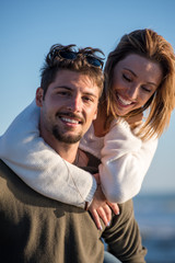 Obraz premium couple having fun at beach during autumn
