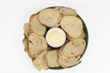 Italian bread toast with butter in a plate isolated in white background seen from above 