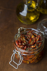 Fototapeta na wymiar Sun dried tomatoes with herbs and spices