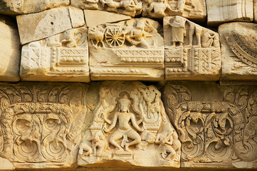 Sandstone carving with religious motifs at the ruins of the Hindu temple in Phimai historical park (Prasat Hin Phimai) in Thailand.